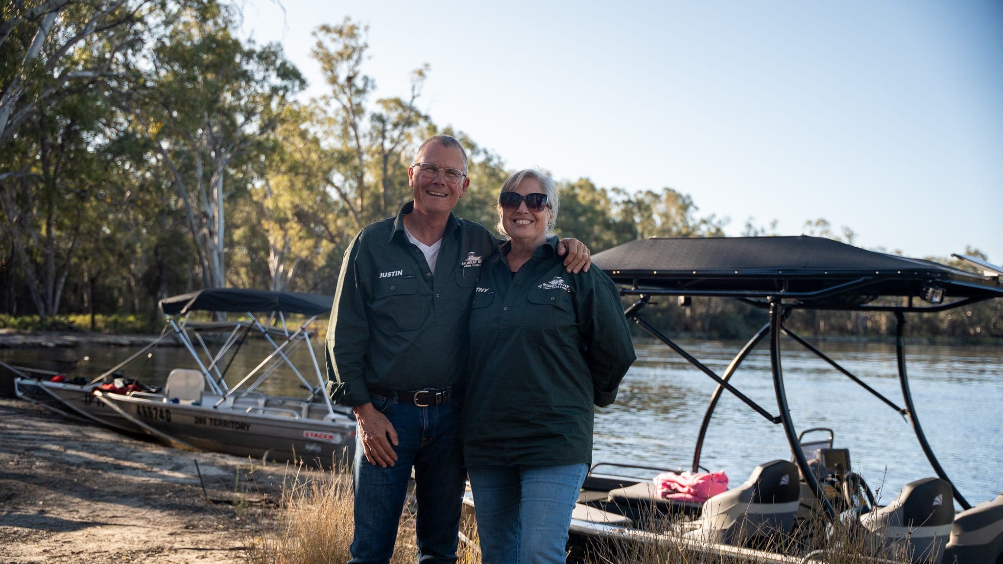 Tour operators Justin and Kathy standing by the water with their tinnies ready for the tour